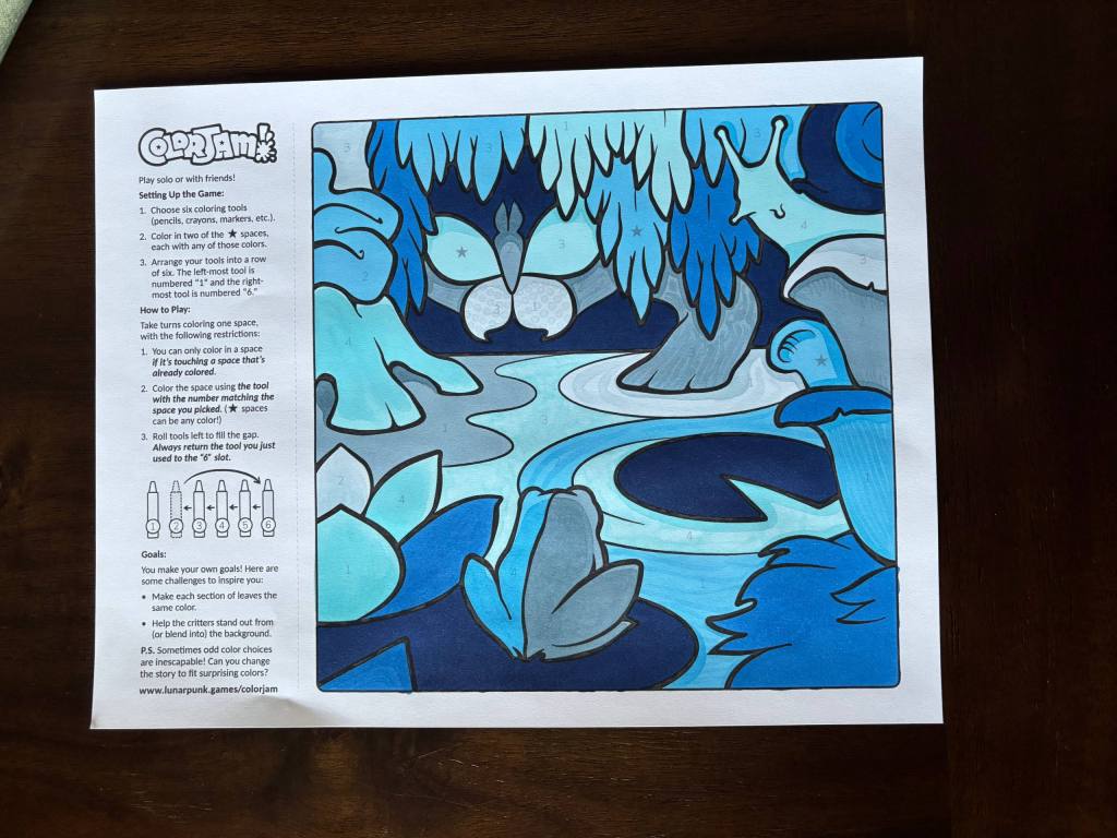 the finished color jam page with a frog, lilypads, trees, a butterfly, and a snail. it's all various shades of blue.