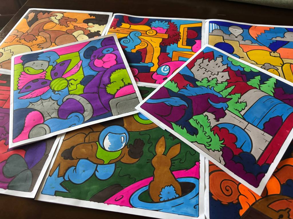 a diorama of different finished pages from Color Jam. included are unicorns, astronauts, a toy box.